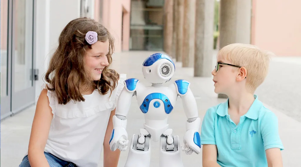 Kinder neben einem blauen Roboter im Freien